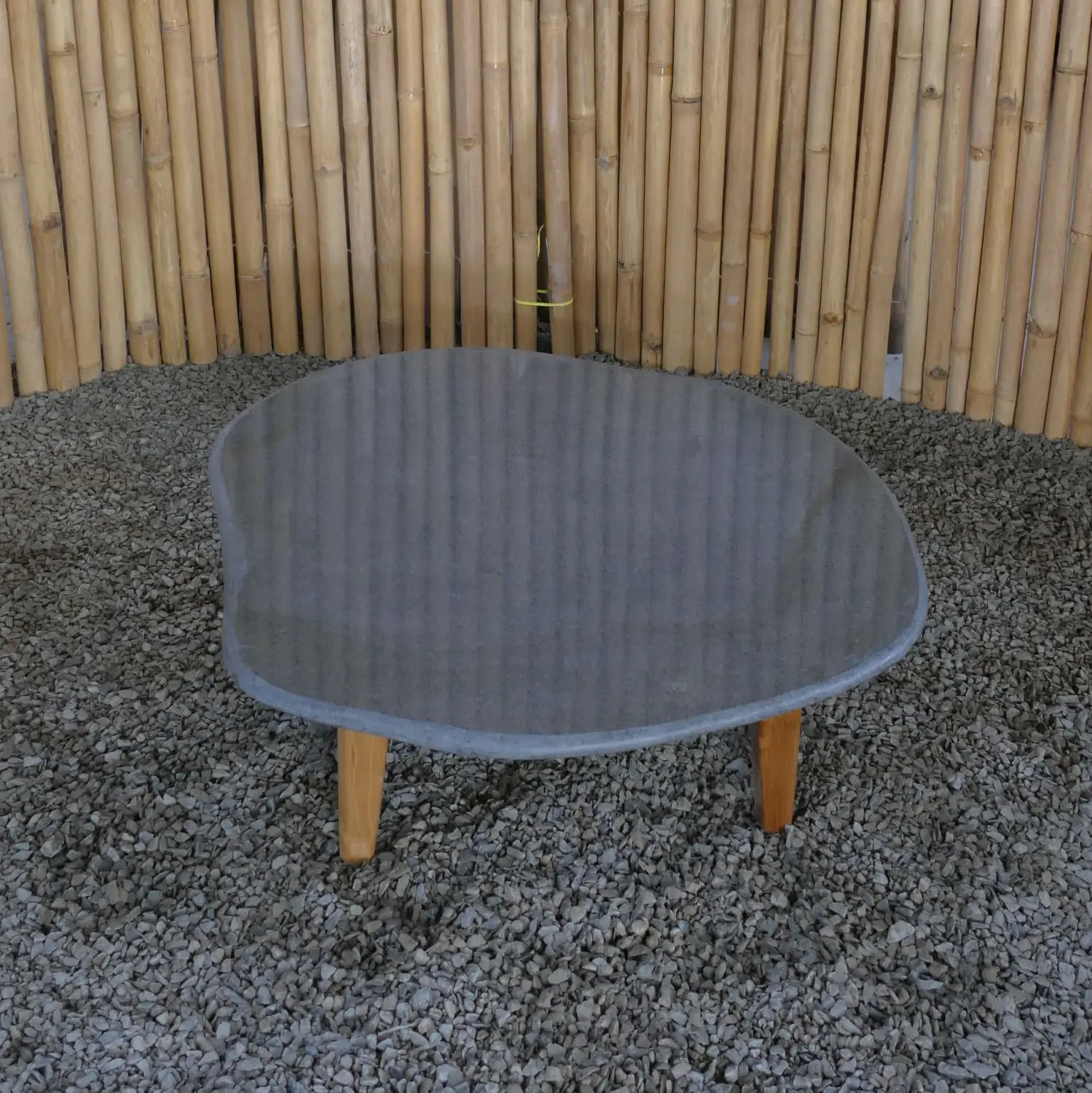  Product image 1 of the product “Unique round flat Table, made from Riverstone slate with teak feet, approx dia. 80cm, 30cm height and 6cm thickness ”